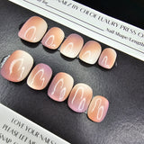 Set of press-on nails with a gradient design on a black surface with a branded box.