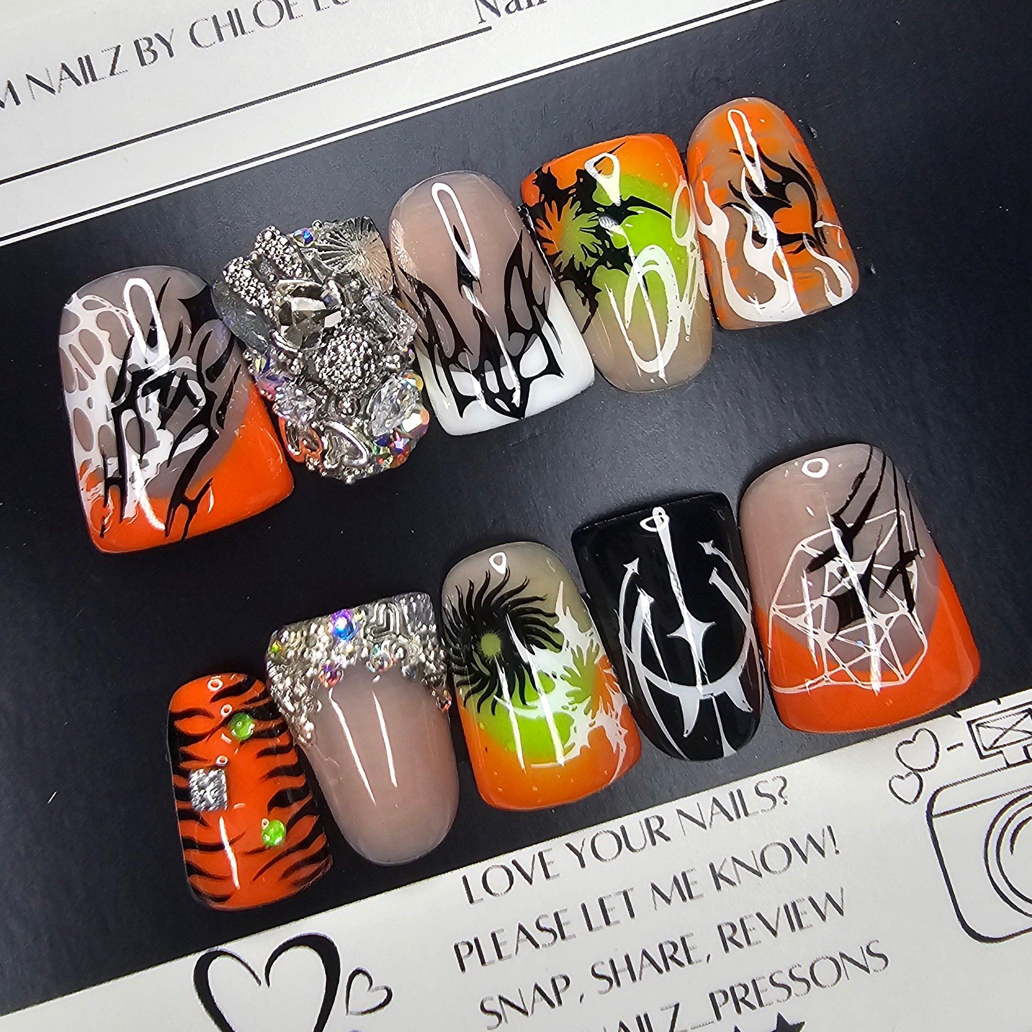 Set of nail art designs on a black surface with a white background